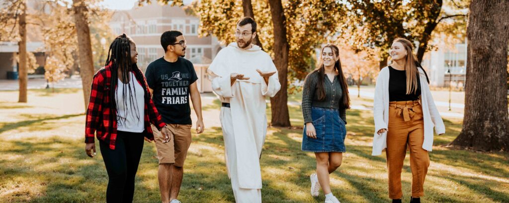 students walk with chaplain