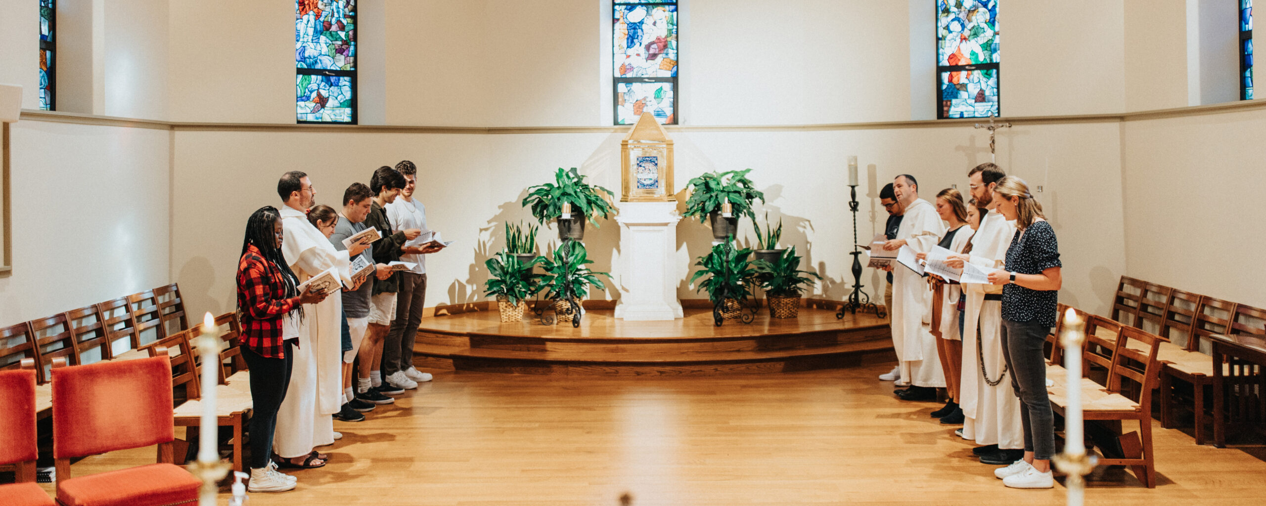 Students and chaplains pray in St. Dominic Chapel