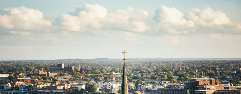 The steeple of the St. Dominic chapel against the Providence skyline