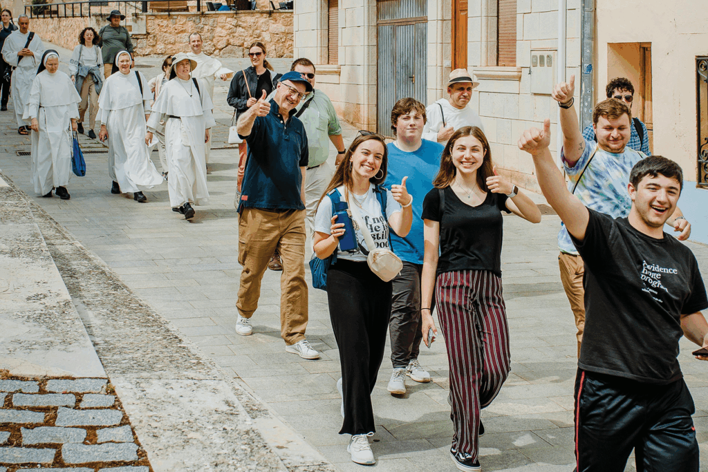 a group walking down a stone paved street