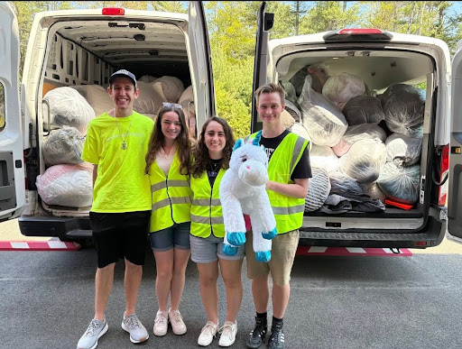 students in front of a van