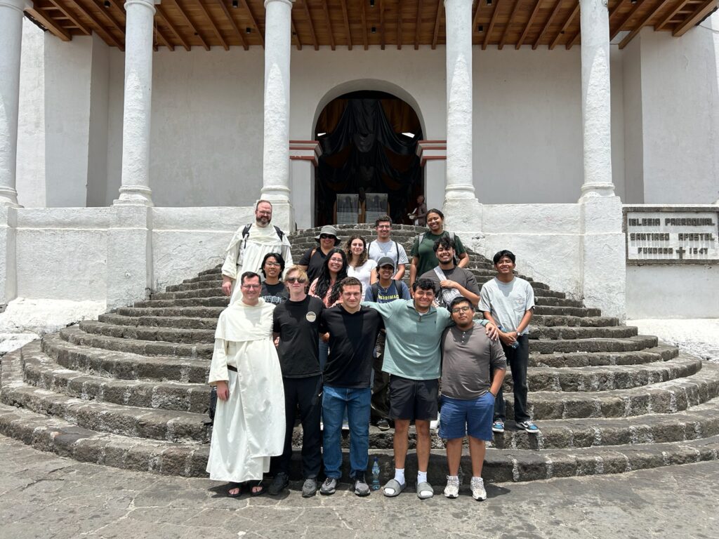 students on steps in front a church
